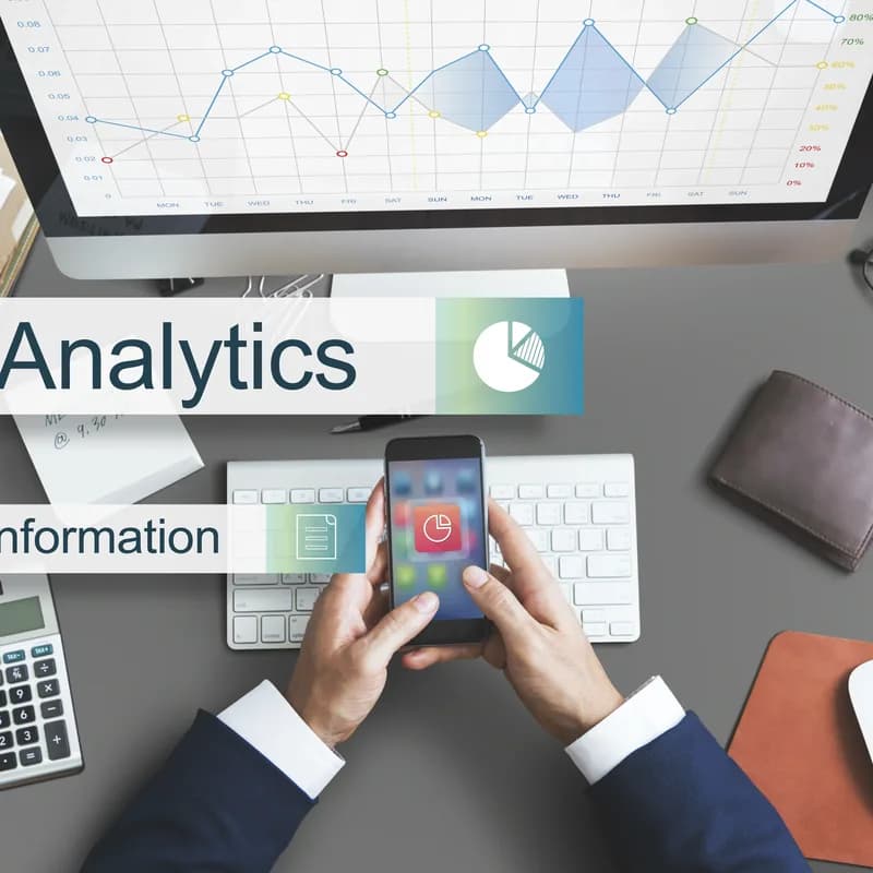 An analytics report and calculator laid out on a desk
