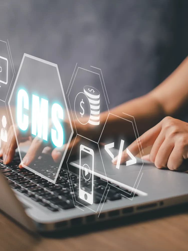 Hands at a laptop with a CMS content management hologram