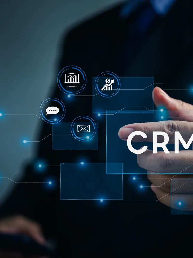 Hands at a laptop with a CRM hologram above the keys