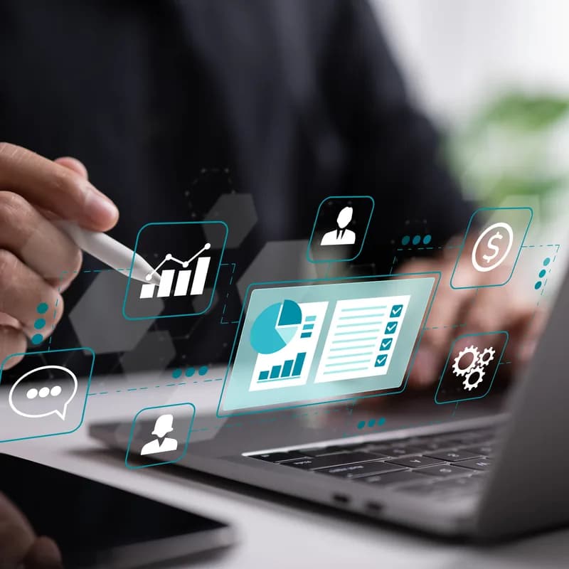 A laptop with a CRM and accounting panel floating above it