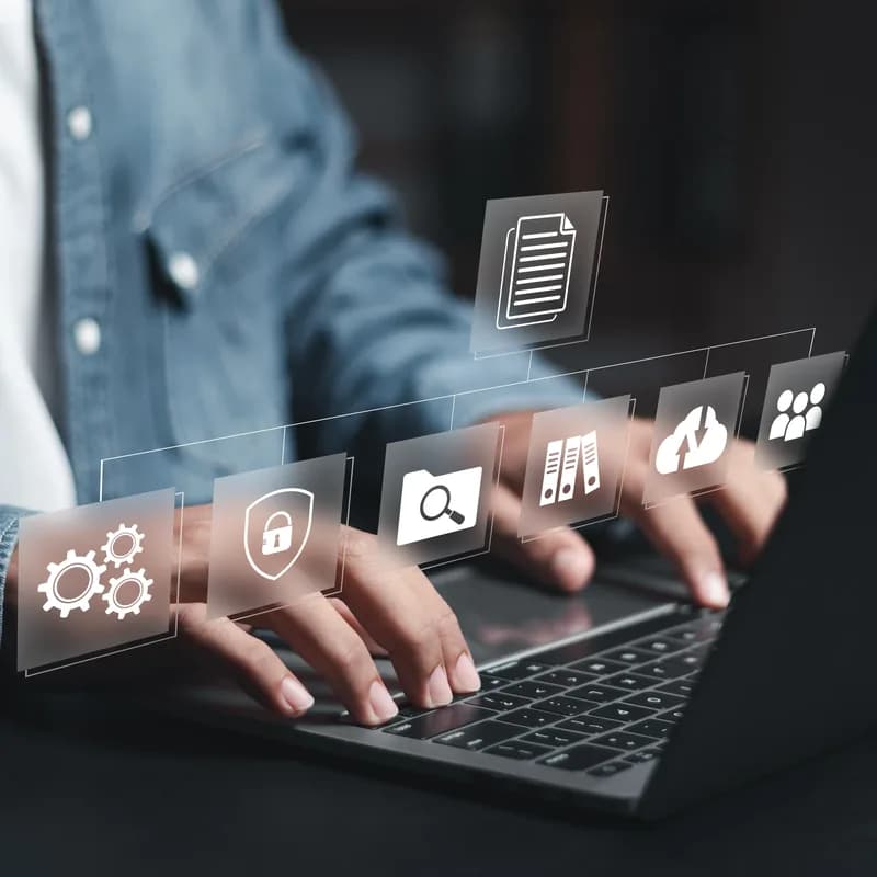 Hands typing with document management icons floating above the keyboard