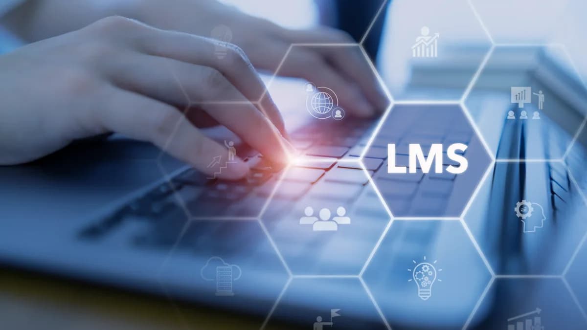 Hands at a laptop with an LMS learning platform hologram