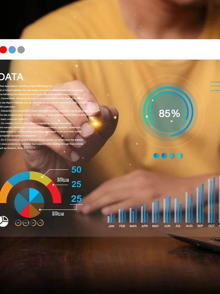 Hands at a laptop with an orange KPI dashboard above the keys
