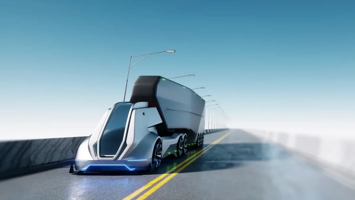 Driverless electric lorry on an open road under a pale sky.
