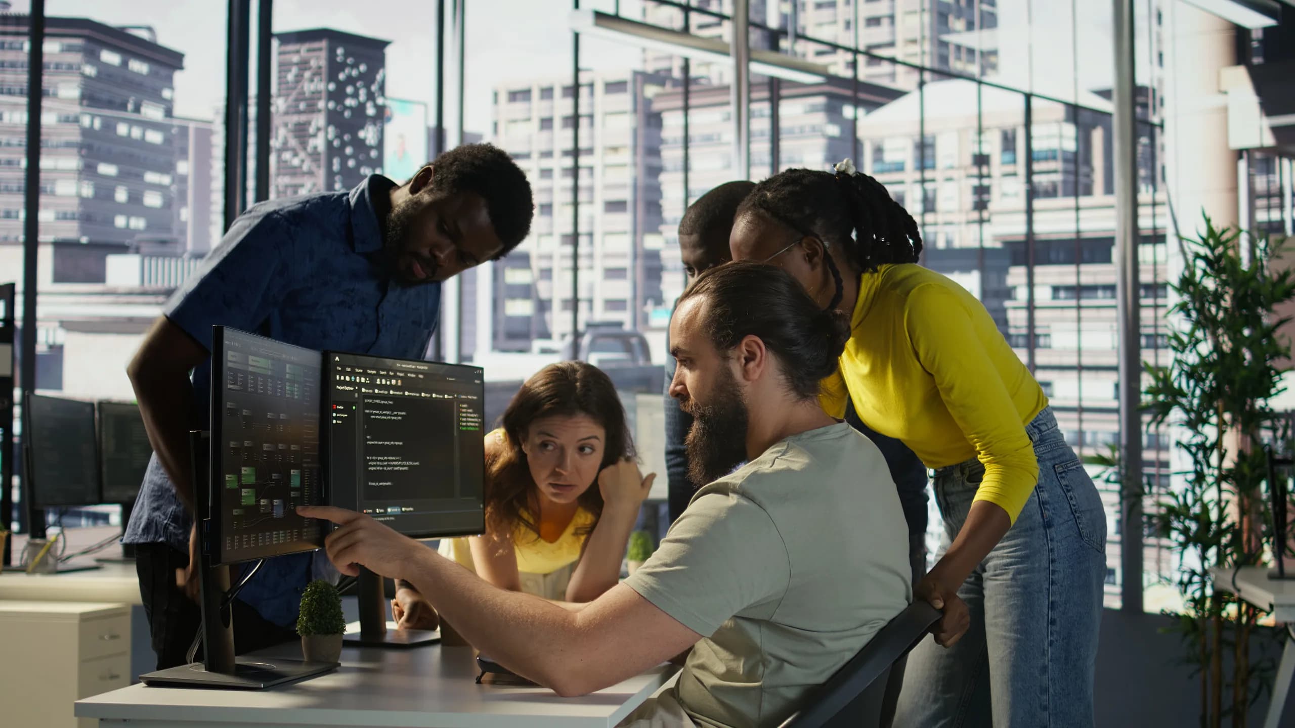 Engineers working together at one long desk