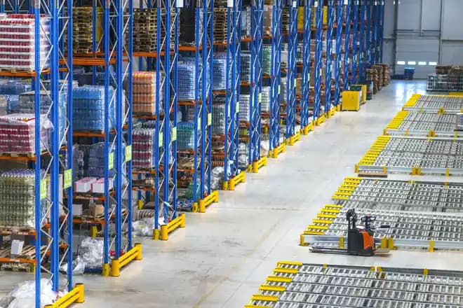 Rows of racking in a distribution centre, lit blue